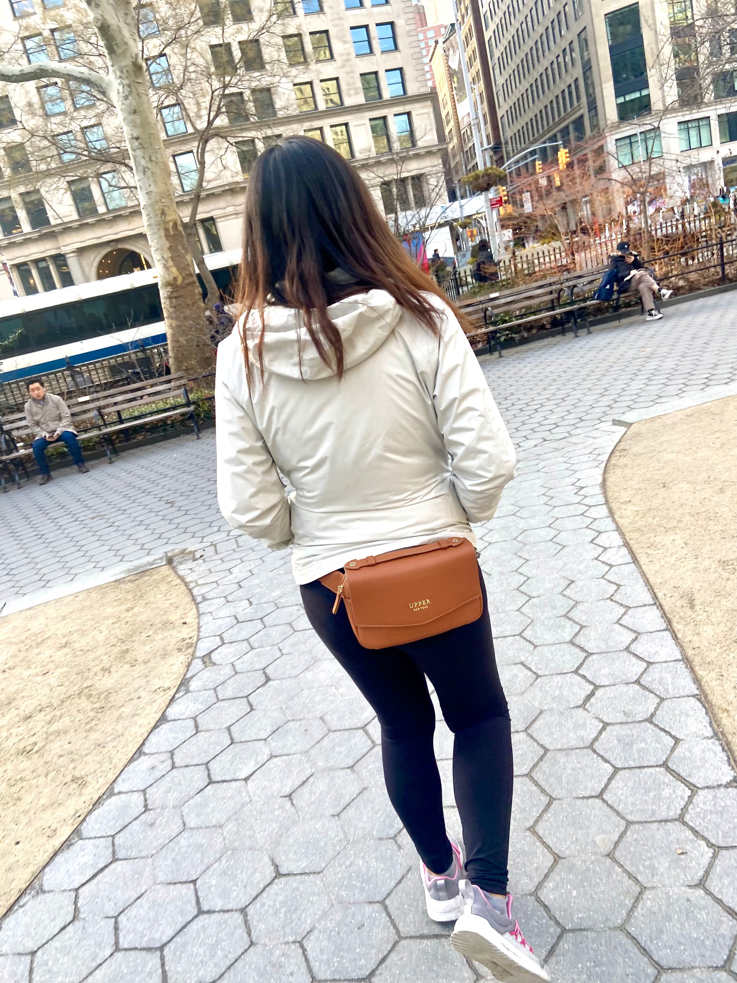 Everyday sling in caramel worn by a mom walking through the park