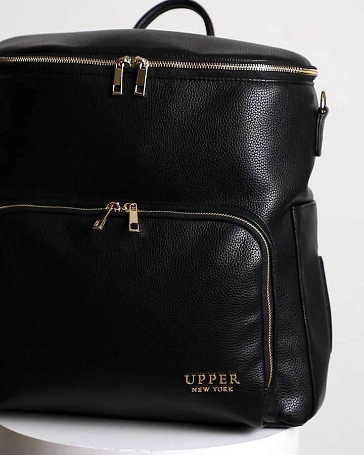 Harvey everyday backpack for parents in black with gold zips, front view