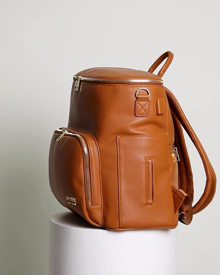 Harvey everyday backpack in caramel, side view showing the side pocket and padded straps