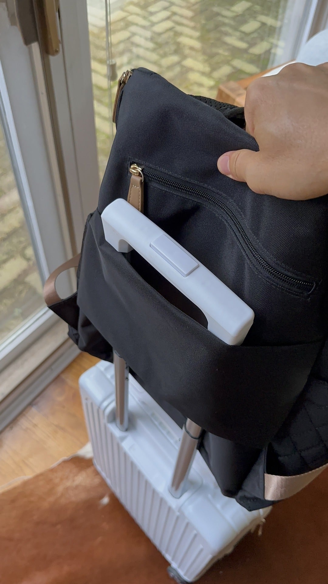 Maison Air backpack sliding onto a carry-on handle